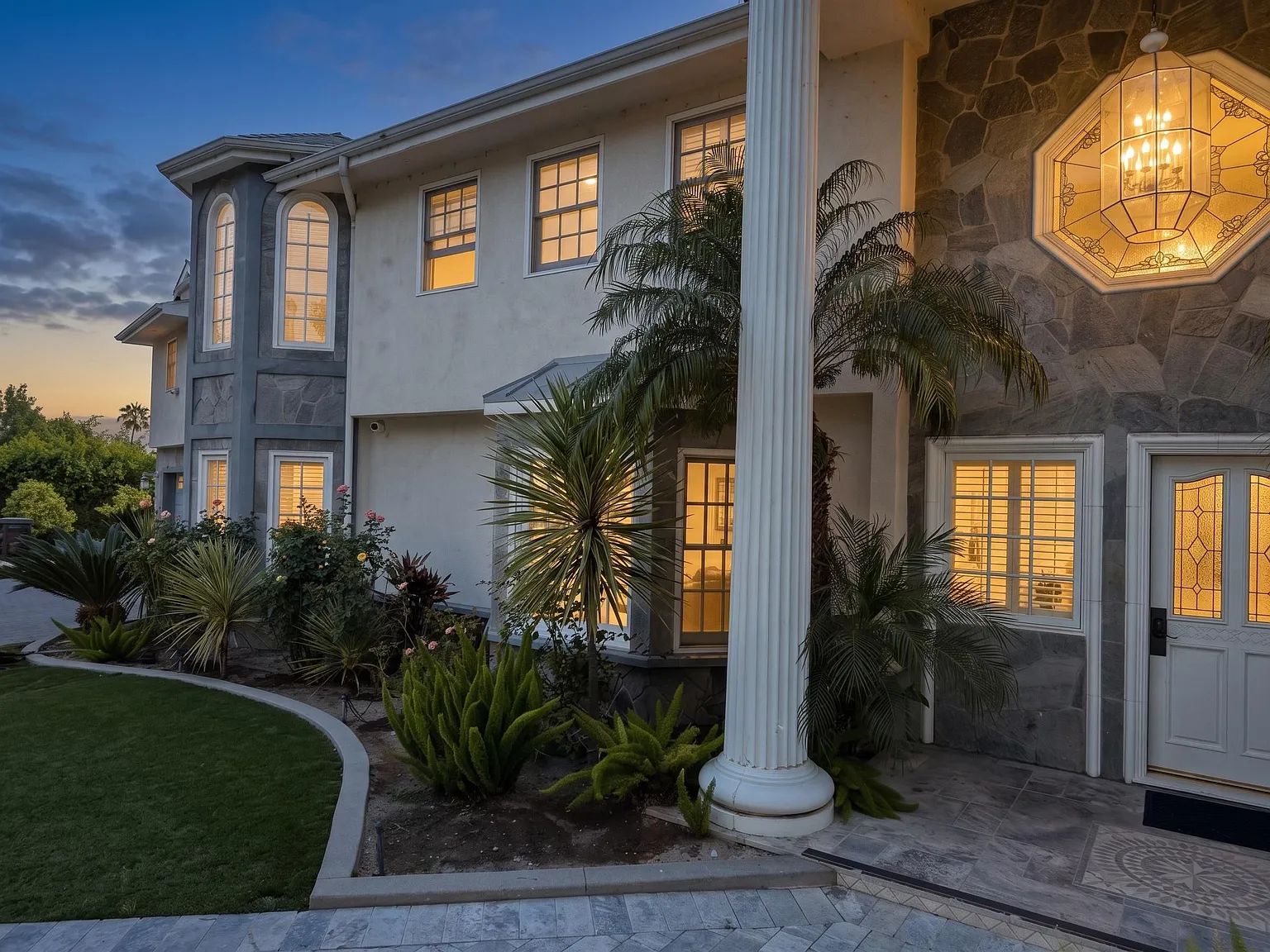 The columned entrance of the Next Phase residence lit at golden hour