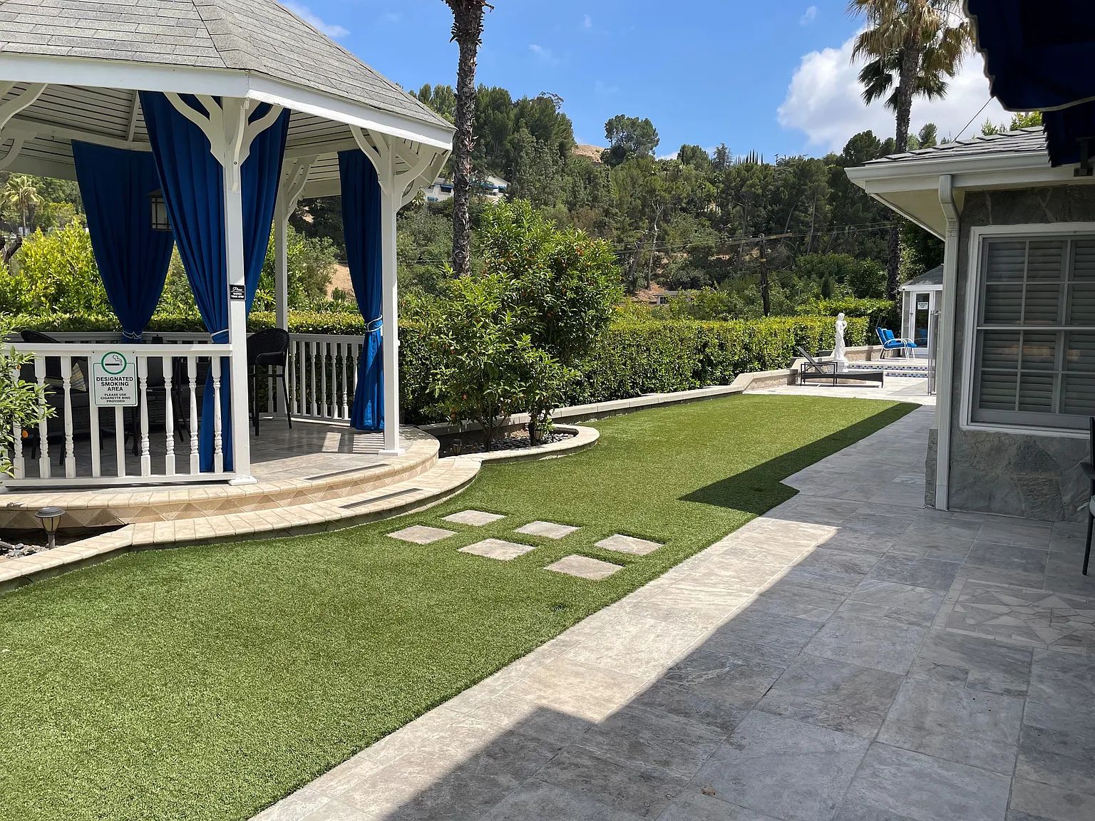 The gazebo and manicured lawn behind the residence