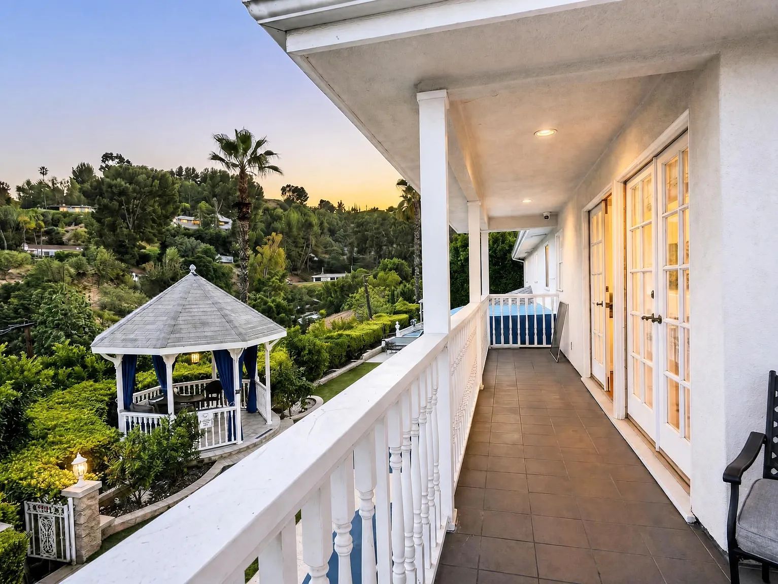A white-railed balcony overlooking the hills