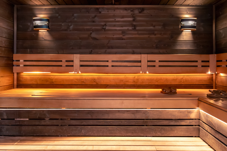 The wood-lined sauna at the Next Phase residence, lit by warm accent lighting