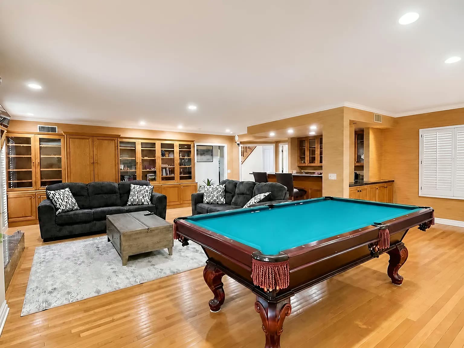 A game room with a pool table at the Next Phase residence